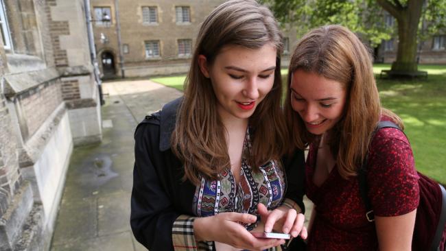 Young women look at a mobile phone