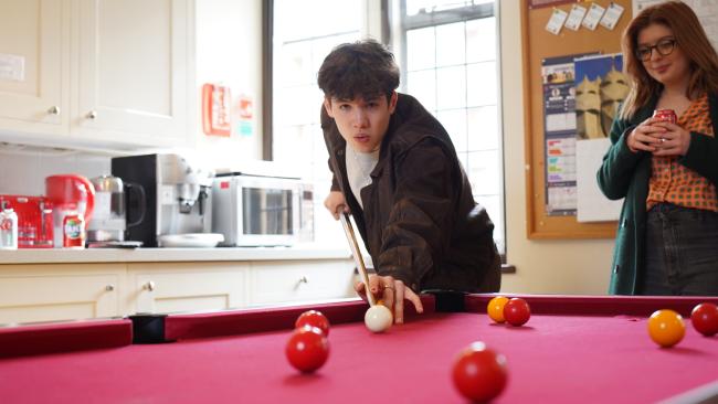 Student playing pool in the MCR